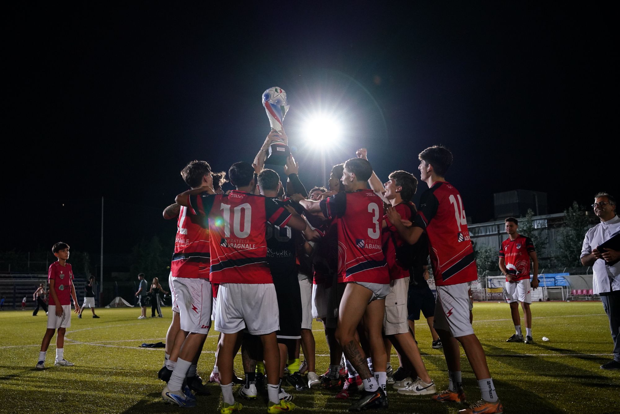 Squadra di calcio esulta di notte sotto i riflettori